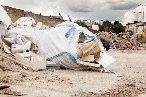 Labeled waste containers and safety signage on a clearance site